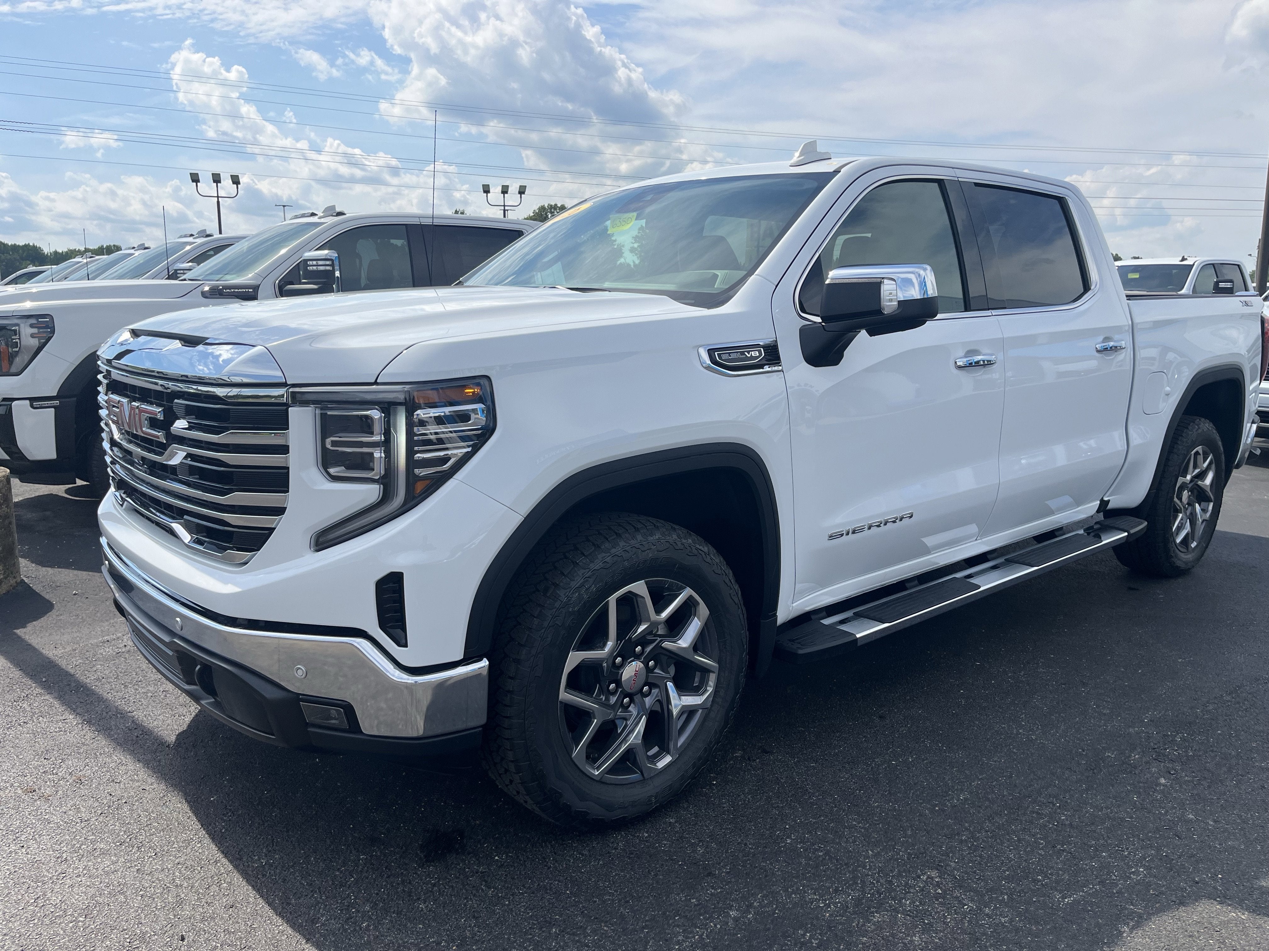 2026 GMC Sierra 1500 SLT in Summit White — front three-quarter view