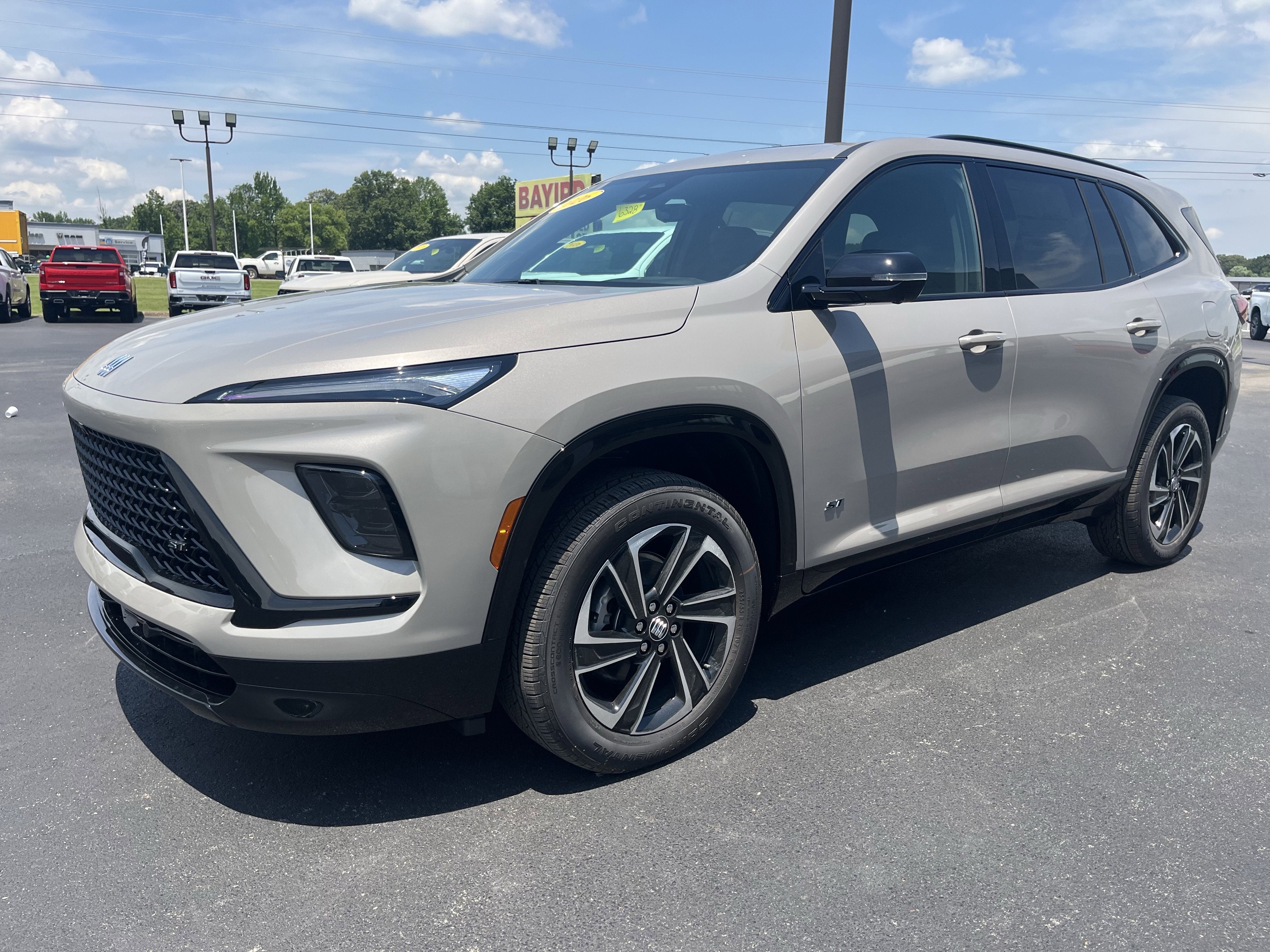 2026 Buick Enclave Sport Touring in Stone Metallic — front three-quarter view