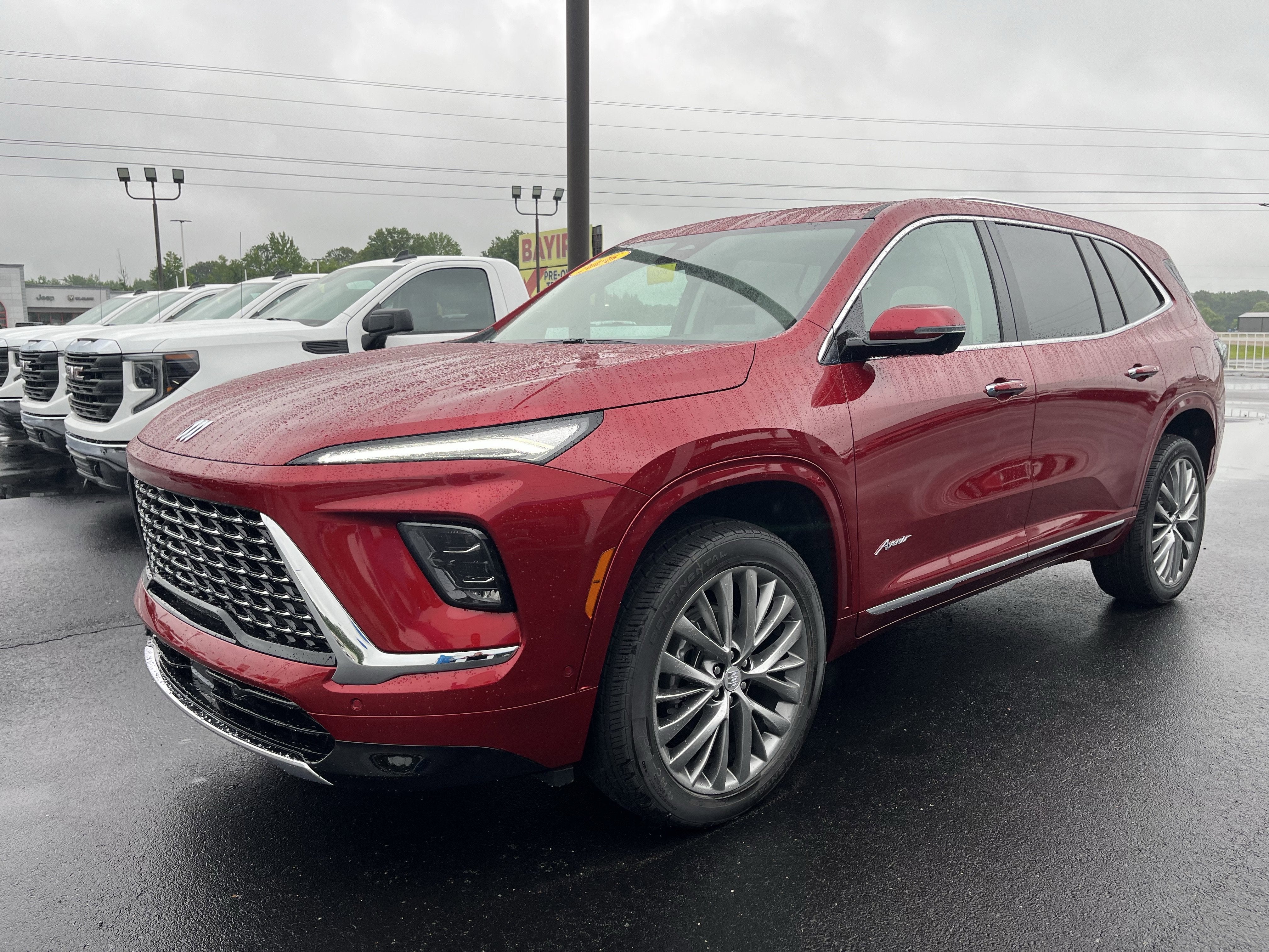 2026 Buick Enclave Avenir in Cherry Red Tintcoat — front three-quarter view